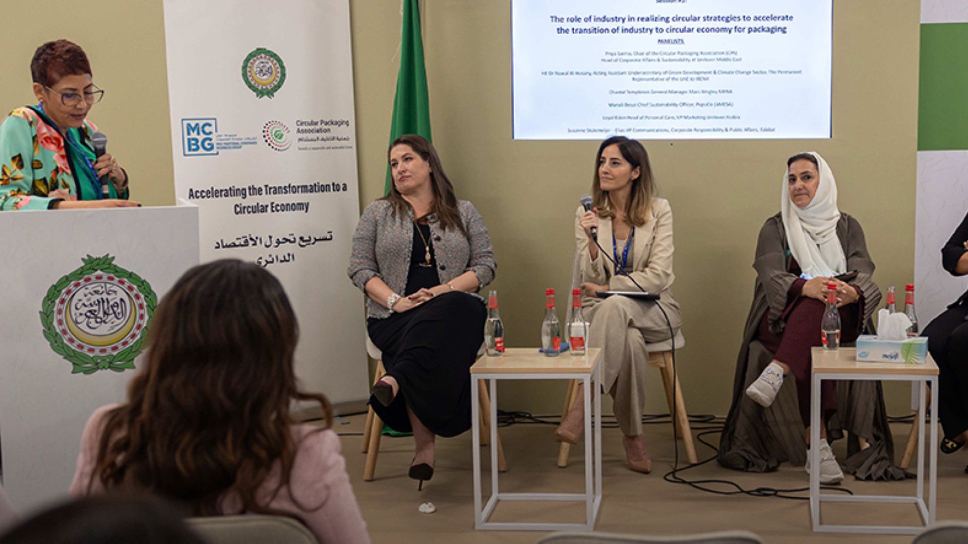Group of panel participants sitting and discussing the topic of accelerating the packaging sector's shift towards a circular economy.