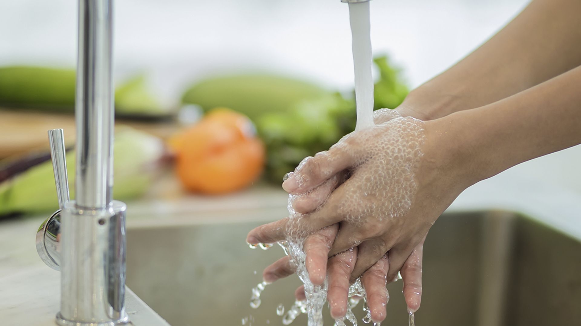 Hands being washed in a sink