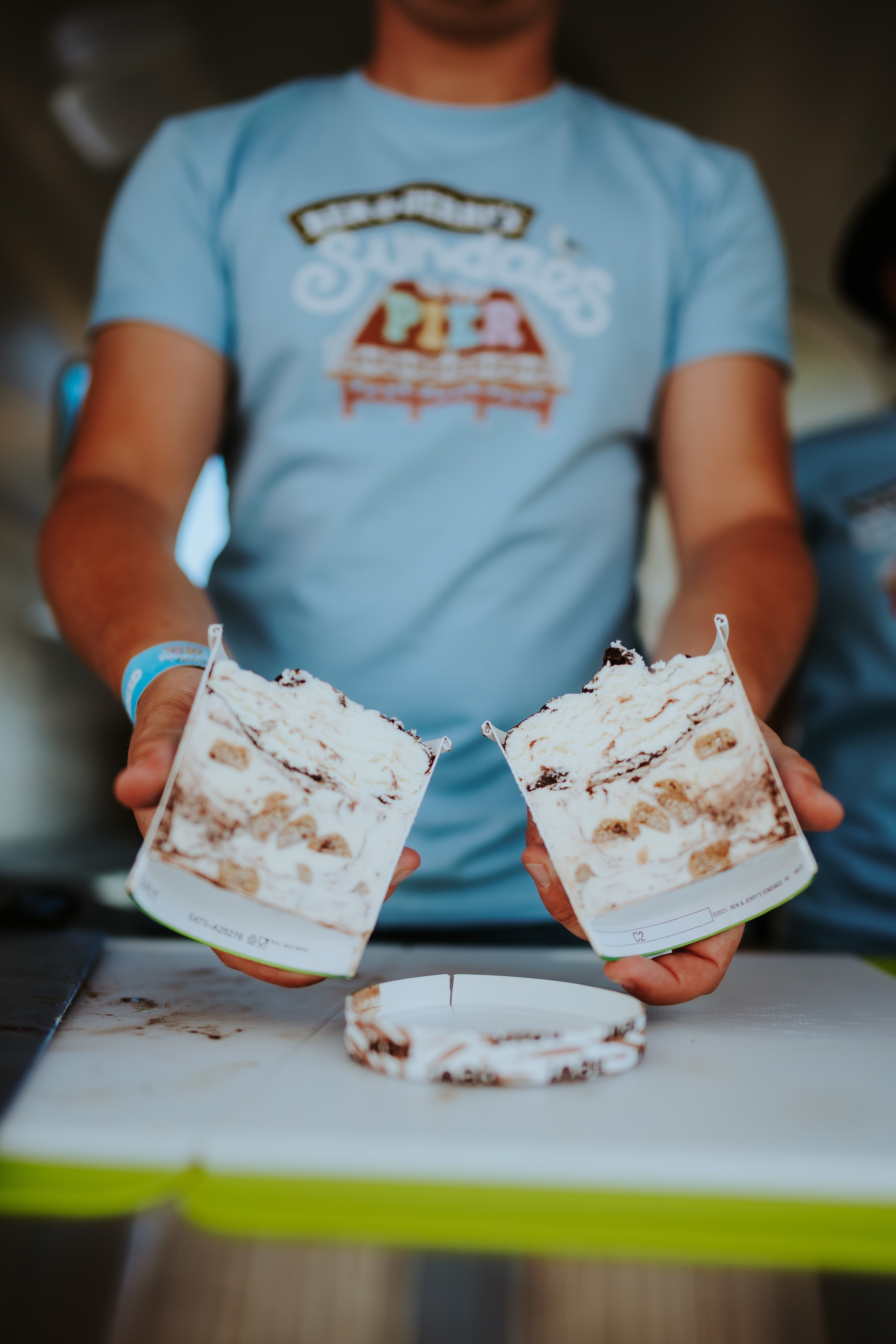 Tub of Ben & Jerry’s Sundae sliced in half, showing the indulgent layers and whipped ice cream topping