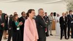 Minister of Climate Change and Environment (female) and Head of Unilever (male) standing and listening to speaker give a speech.