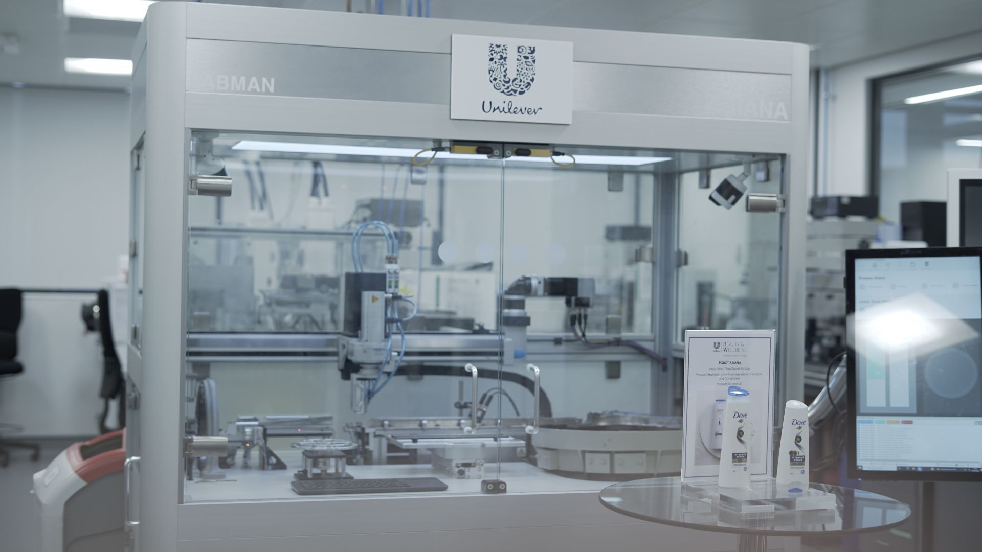 The ‘Ariana’ robot used to develop Dove hair products for Unilever. A large, glass-fronted box with a device inside.
