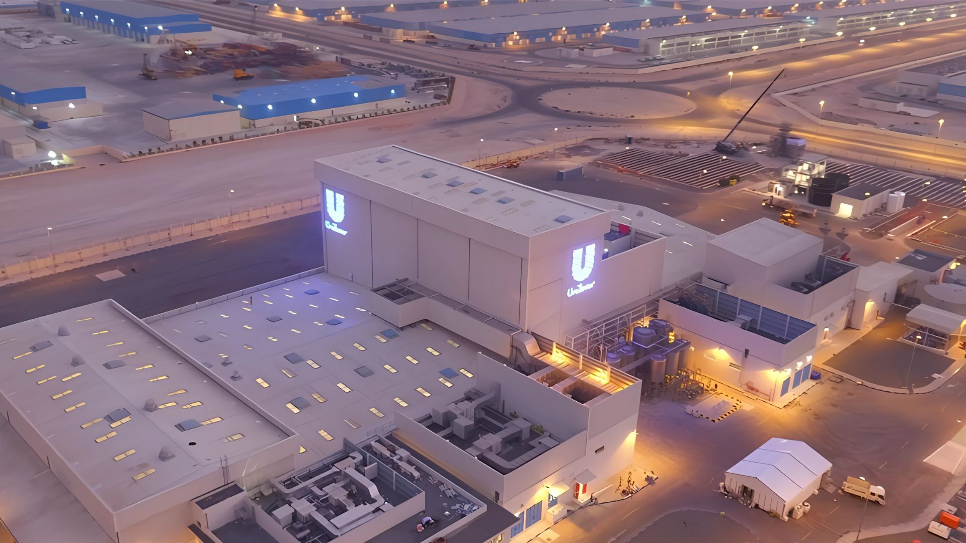 Aerial view of Unilever manufacturing and office facilities, showcasing large industrial buildings, parking areas.