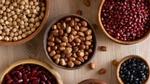 An aerial view of bowls filled with a variety of beans and pulses