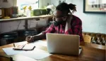 Man with beard working at laptop. Unilever Flex Experience matches people with projects that offer the chance to upskill.