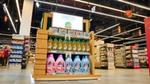Supermarket display of cleaning products under a “Together for the Planet” sign.