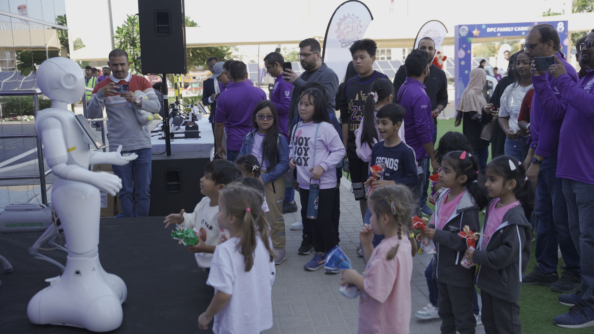 Families celebrating at Dubai personal care factory family carnival