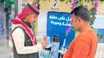 A Rexona representative shows a deodorant product to a customer at a retail display.