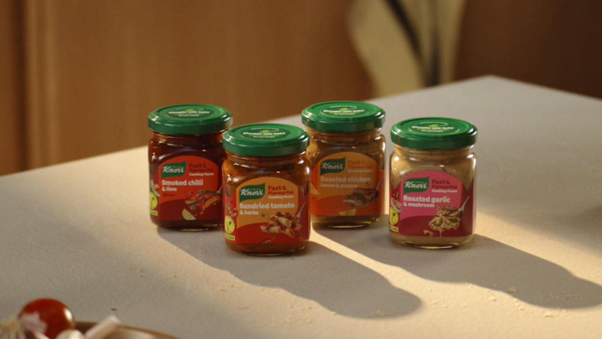 Four jars of Knorr Fast & Flavourful Paste are pictured on a white kitchen counter. AI cut the development time in half.