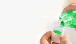 A photo of mouthwash in a glass