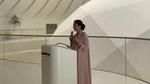 Minister of Climate Change and Environment (female) standing at a podium giving a speech.